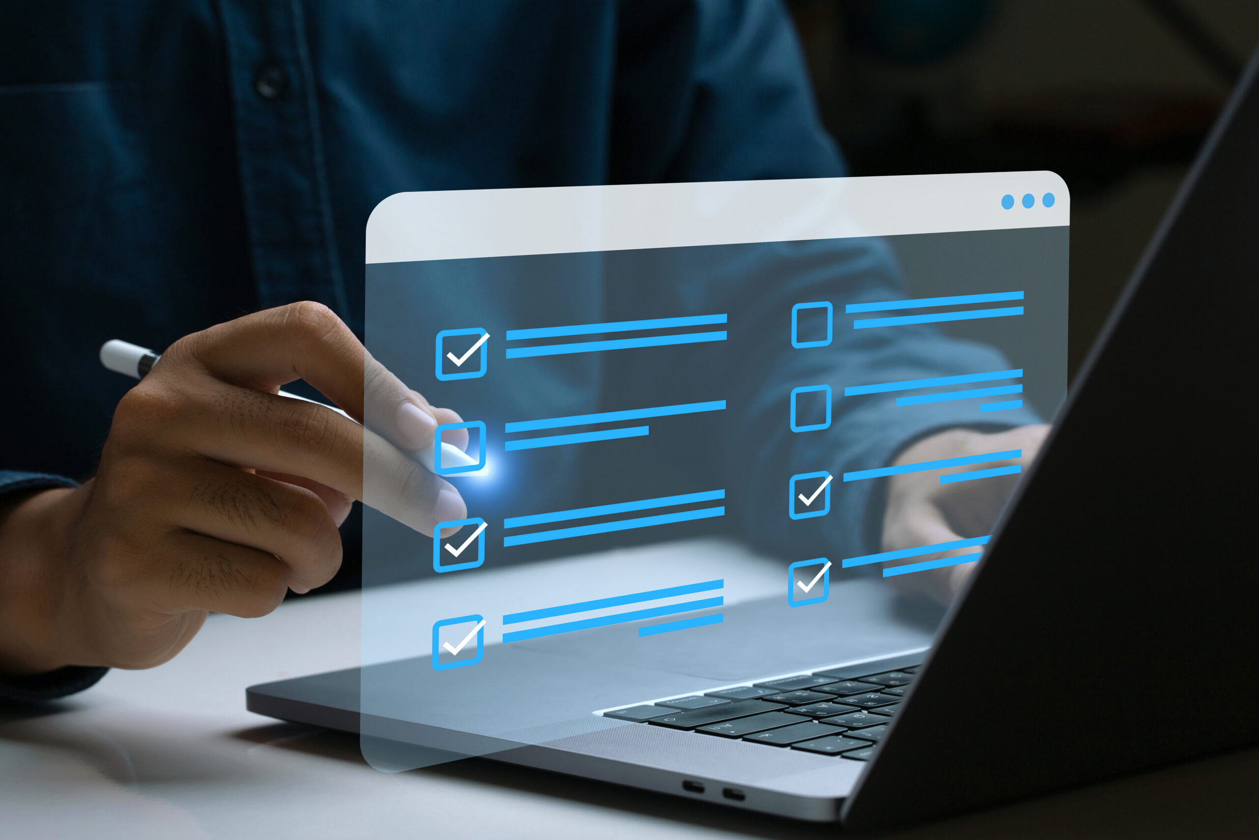 Digital checklist appearing over a laptop, representing an application and software inventory