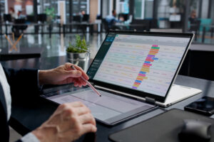 Data and checklists on a laptop screen, showing the importance of employee beneft plan cybersecurity.