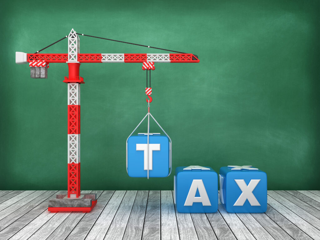 Illustration of a crane lifting blocks reading "TAX" into place, representing the benefits of coordinated construction tax planning.