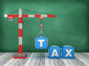Illustration of a crane lifting blocks reading "TAX" into place, representing the benefits of coordinated construction tax planning.