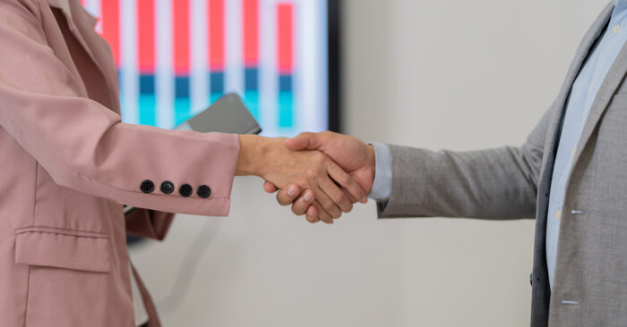 Two nonprofit leaders shaking hands.