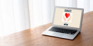 Laptop screen showing a graphic that says "Donate," representing the need for well-prepared charitable gift acknowledgments.