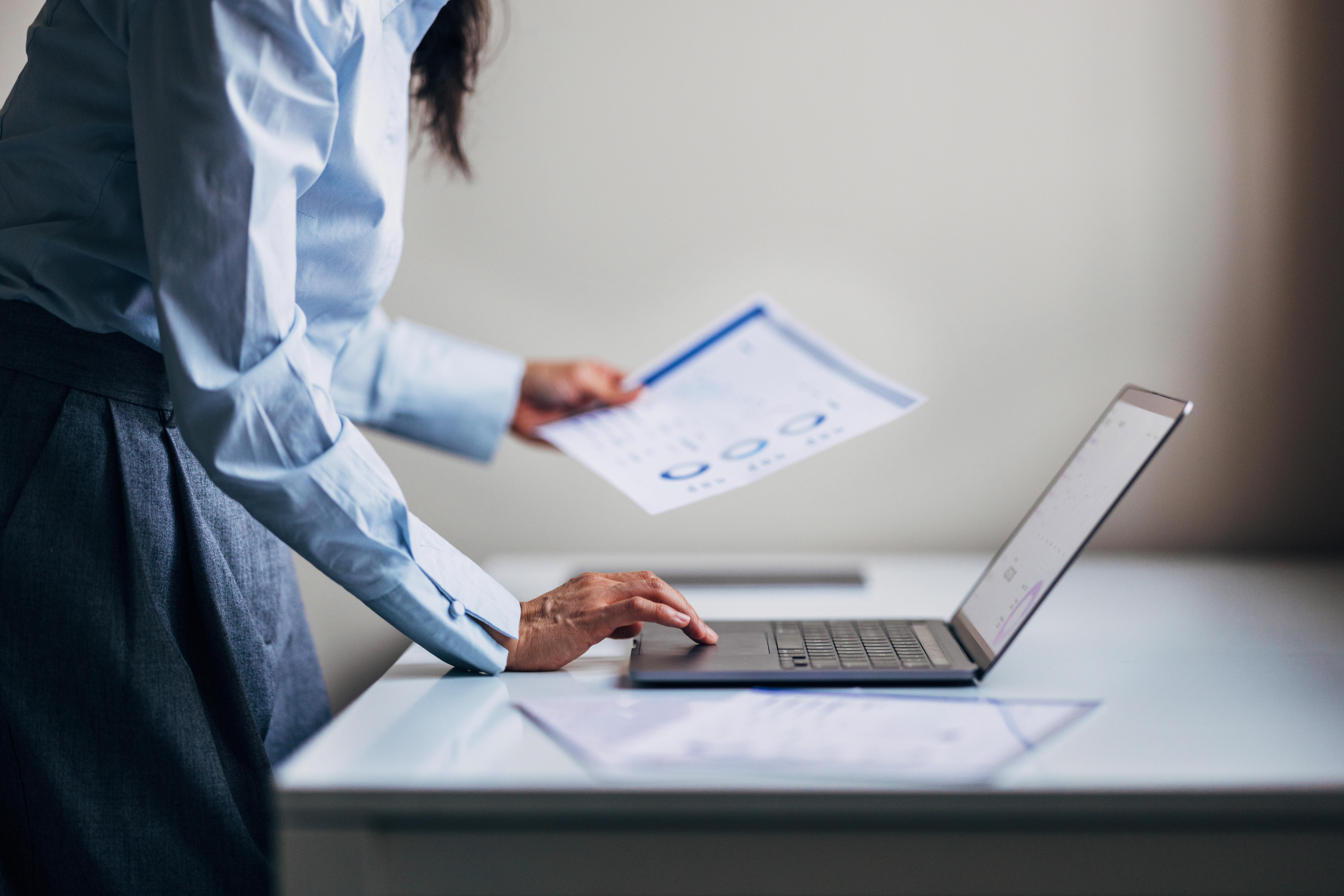 Financial leader at a laptop, representing the importance understanding the Department of Education financial responsibility regulations.